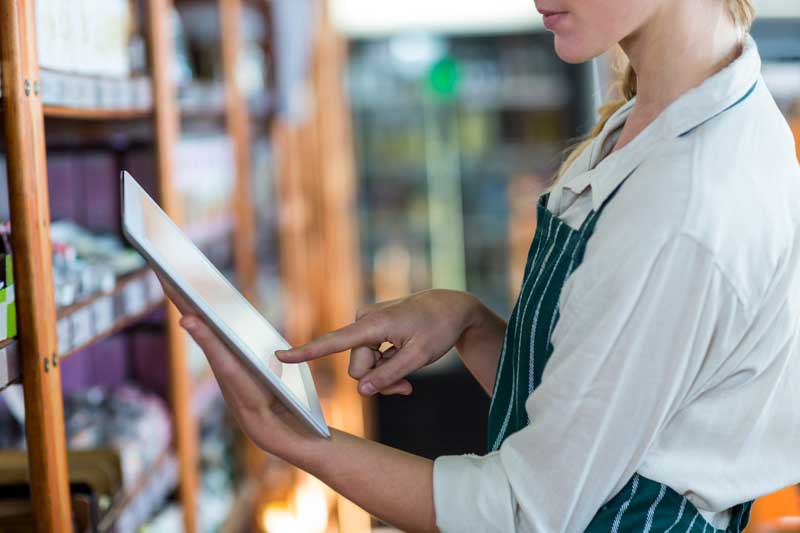 cbd oils and edibles - woman looking at inventory in store